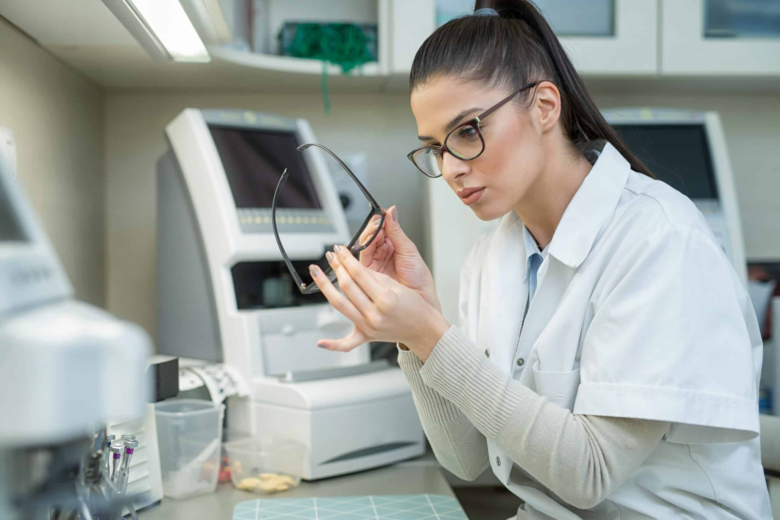 female optical technician working on prescription glasses